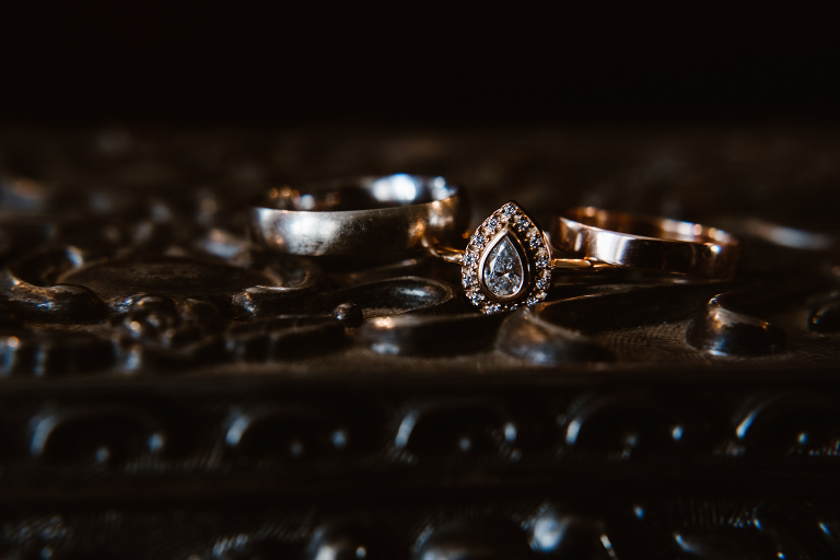Texas wedding photographer, Moody photo of a set of wedding rings at Stonebridge Wedding Venue